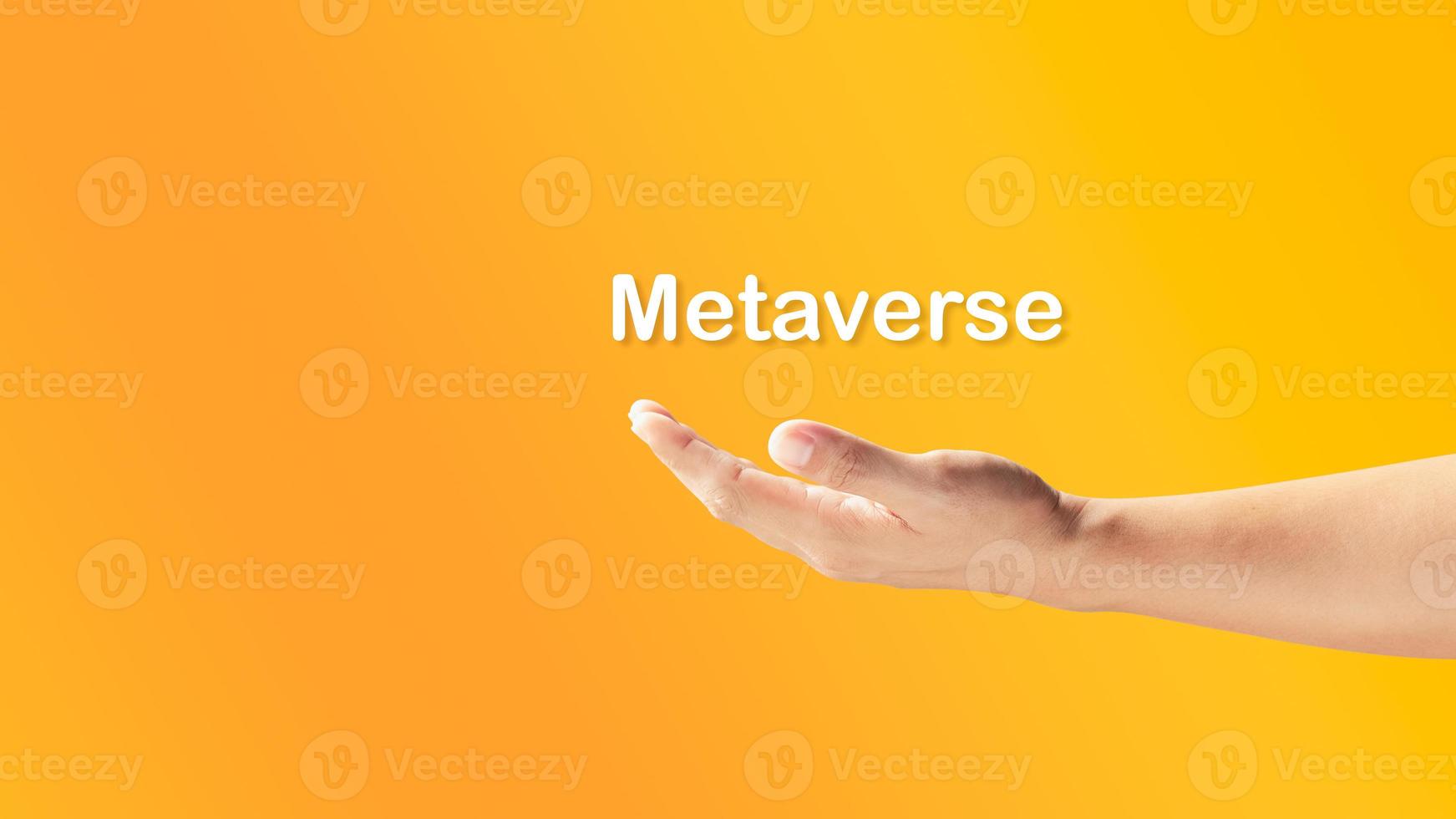 mannens hand håller ordet metavers, virtuell verklighets värld, tomt utrymme för text, banderoll. foto