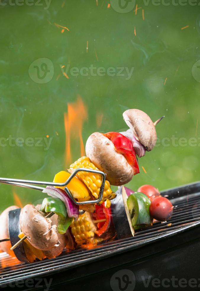 grillade vegetariska spett i eld foto