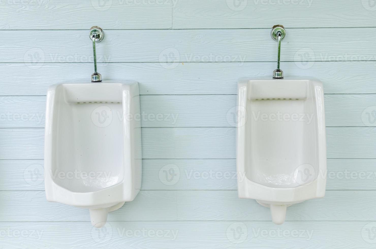 rad med vita urinaler i mäns badrum foto
