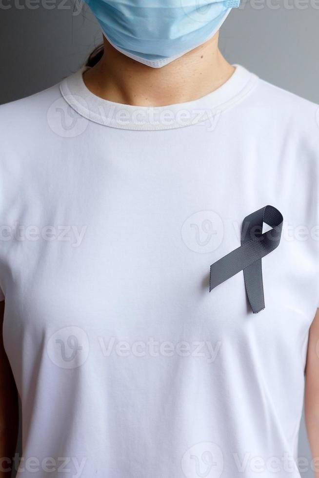 svart band för melanom och hudcancer, vaccinskada medvetenhetsmånad, sorg och vila i frid. sjukvård och rasistiskt koncept foto