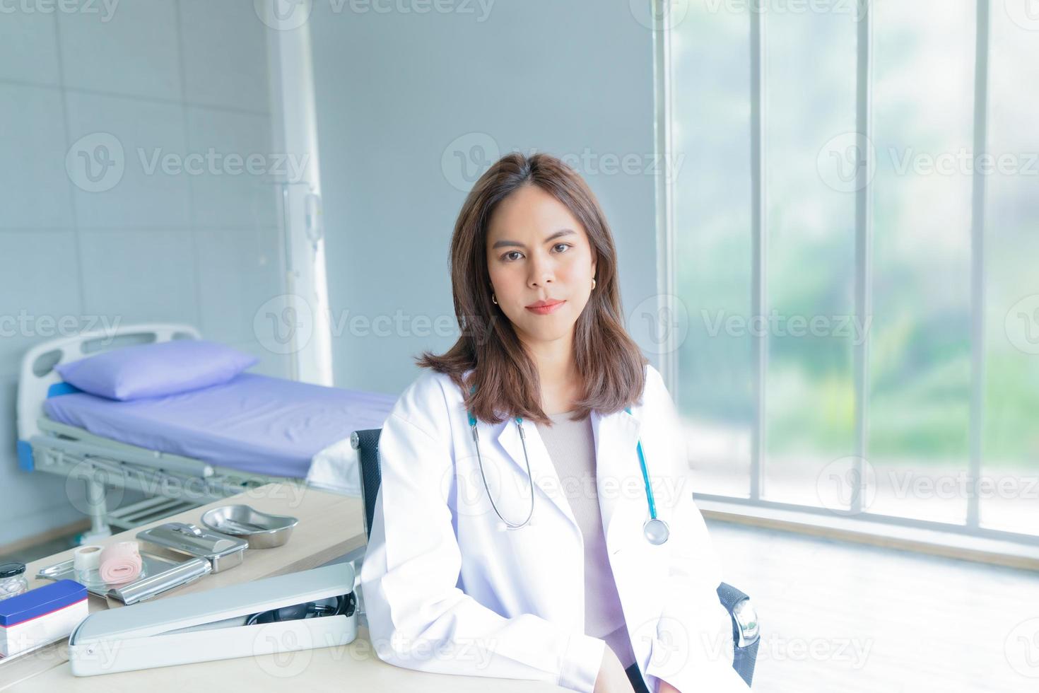 en kvinnlig läkare arbetar på ett kontor på ett sjukhus eller en klinik. leende och självsäker kvinna foto