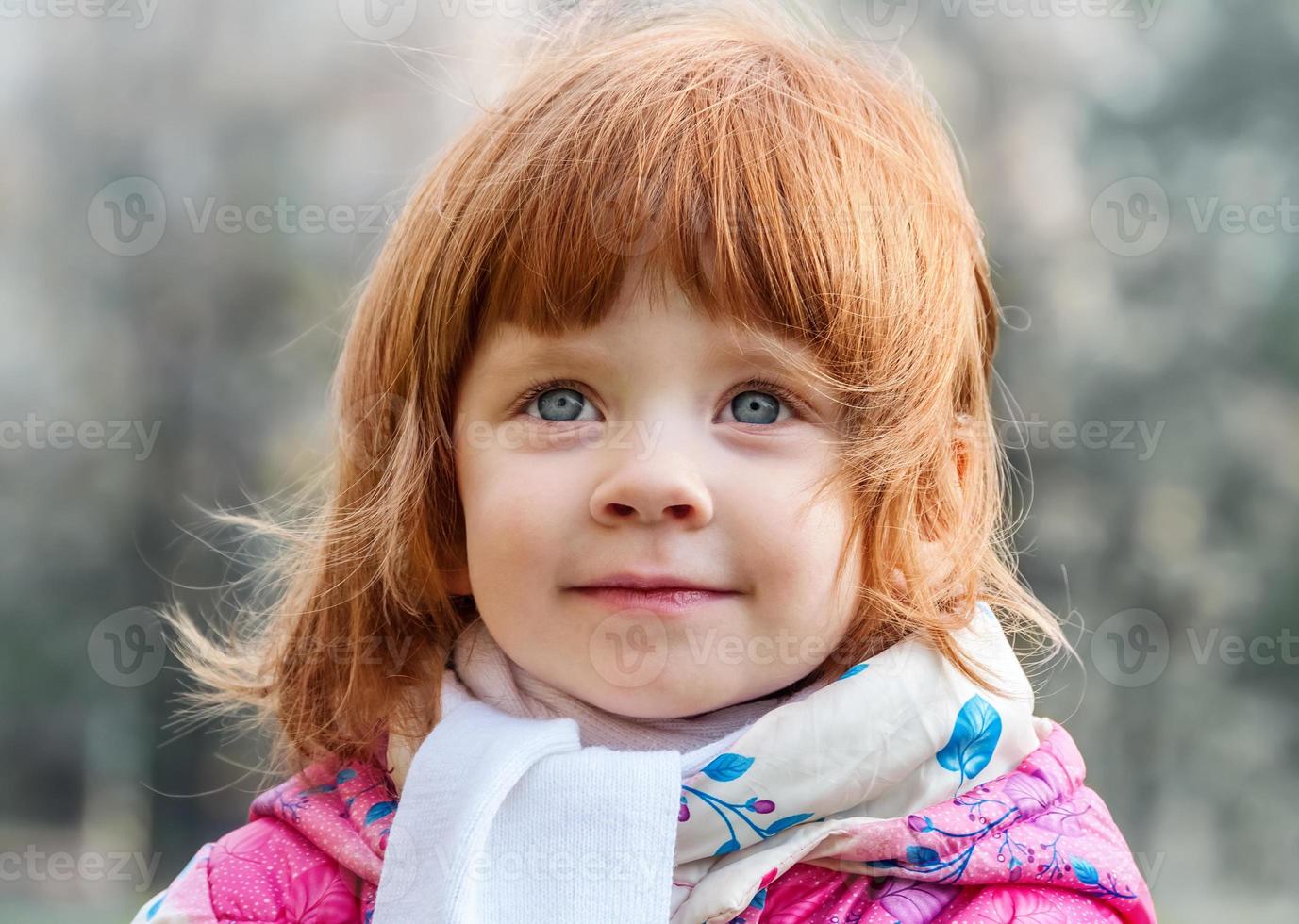 porträtt av en vacker liten flicka i parken foto