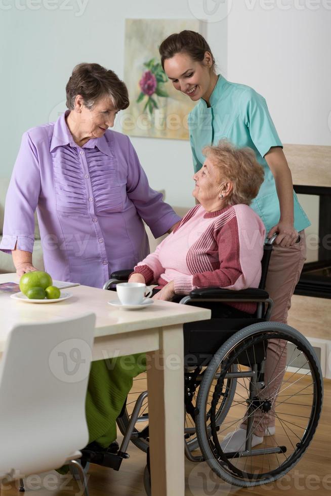kvinna på rullstol, vän och sjuksköterska foto