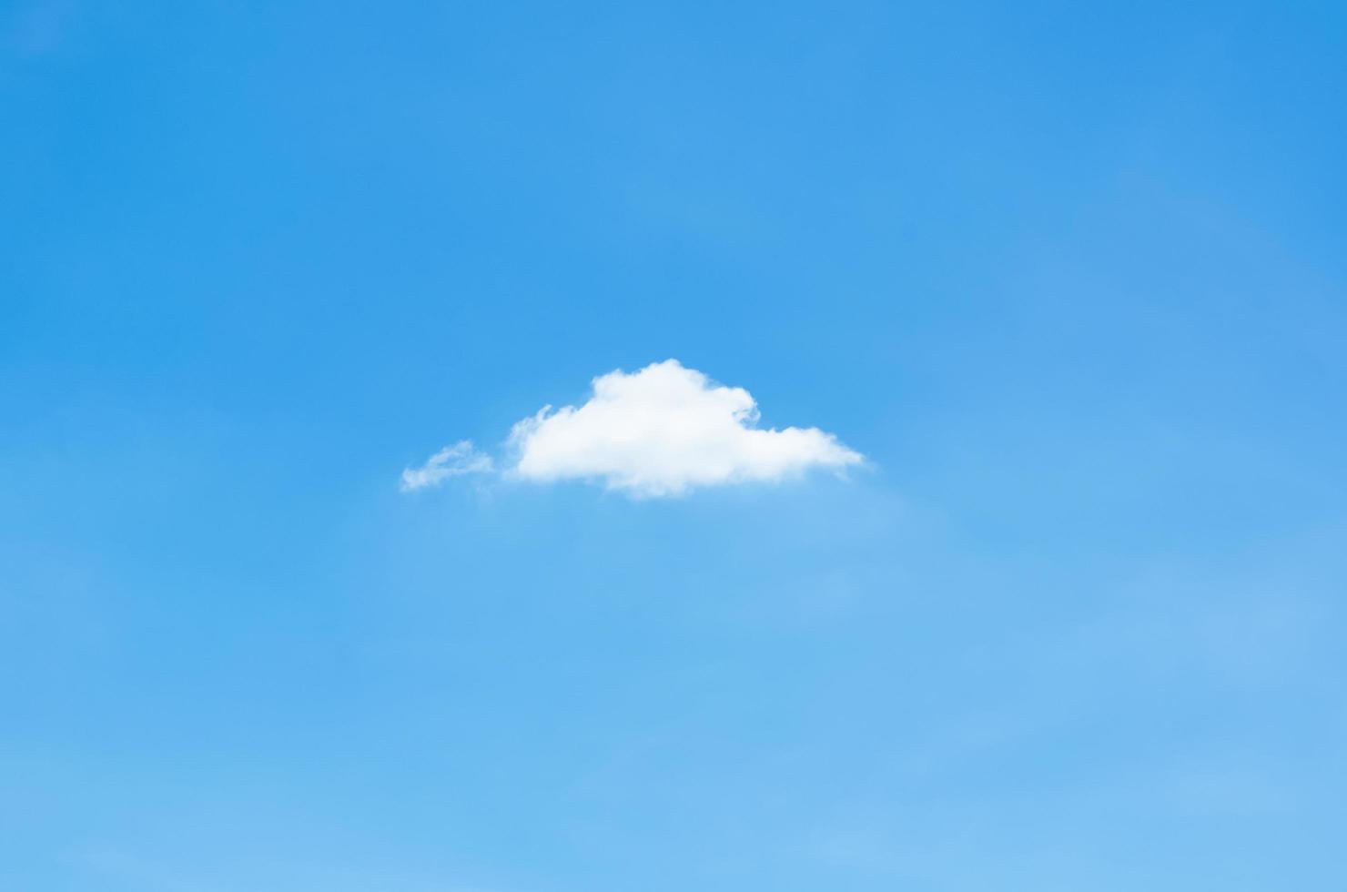 enda vita moln stanna ensam i klarblå himmel på sommaren. foto