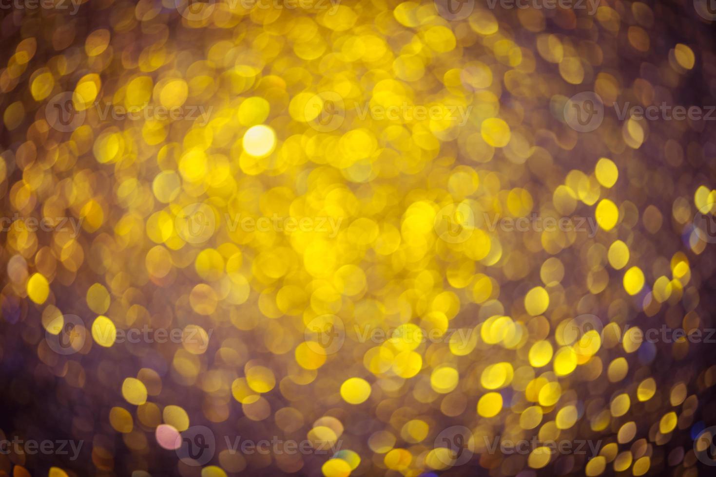 gyllene glitter bokeh belysning textur suddig abstrakt bakgrund för födelsedag, årsdag, bröllop, nyårsafton eller jul foto