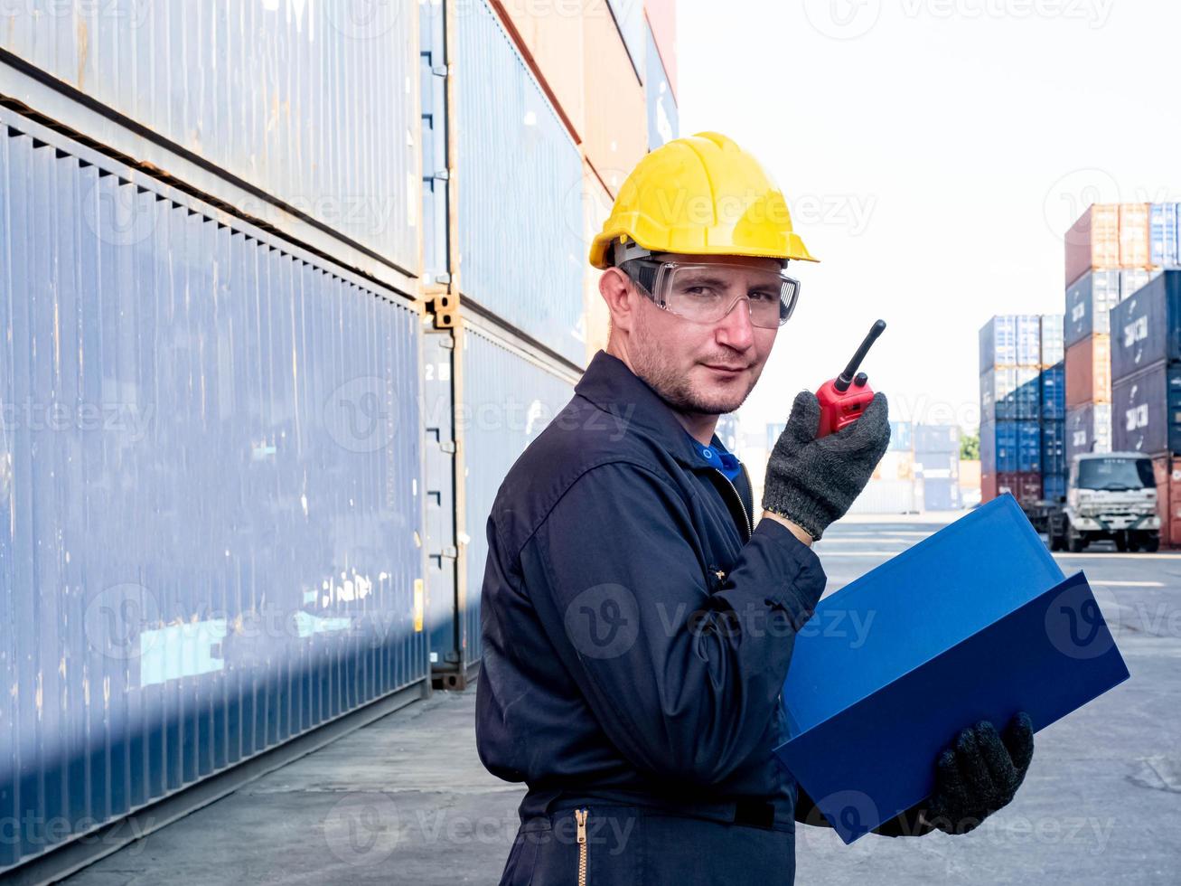 förman ingenjör chef europa gul hatt svart skugga säkerhet prat telefon titta arbete rapport lager terminal container import export företag företag webbplats kund logistik global internationell foto