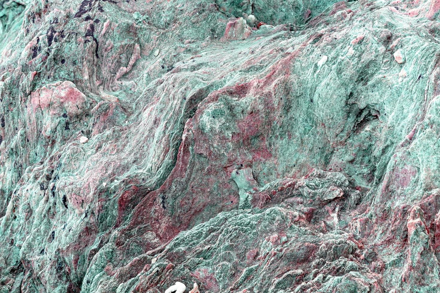 närbild färgglada magmatiska sten bakgrund foto