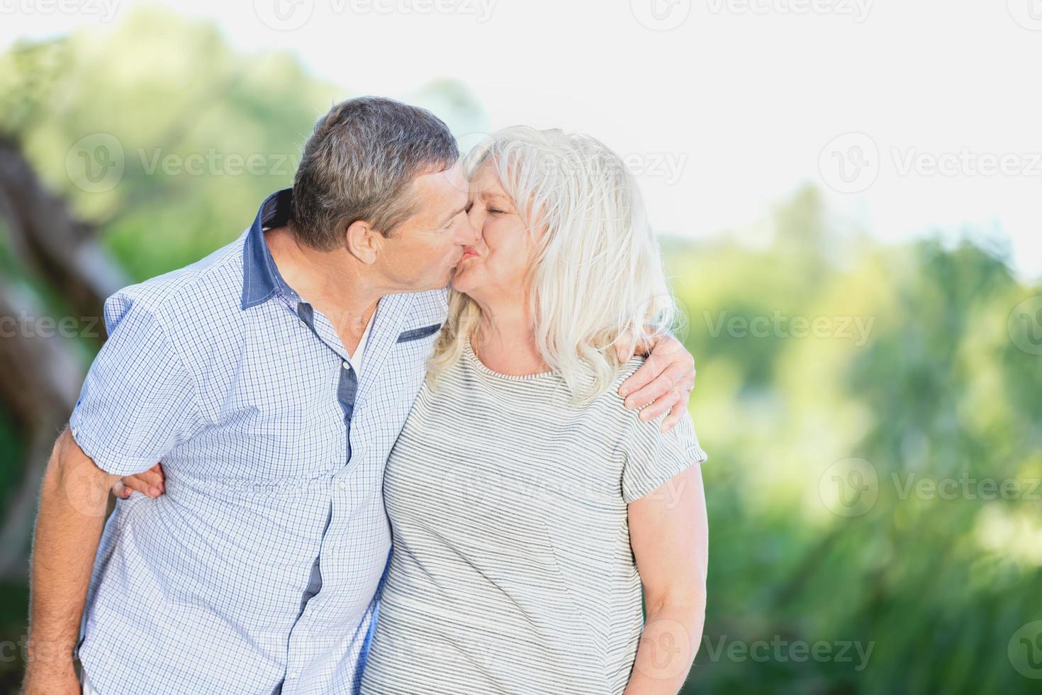 senior äktenskap kysser kärleksfullt foto