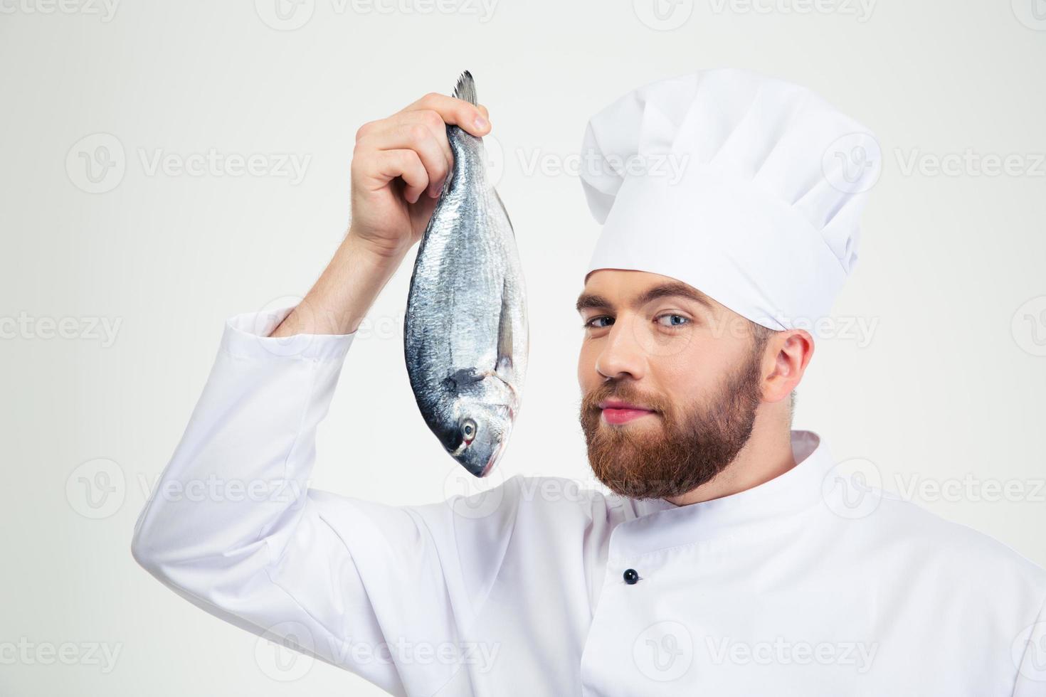 stilig manlig kockkock som håller fisk foto
