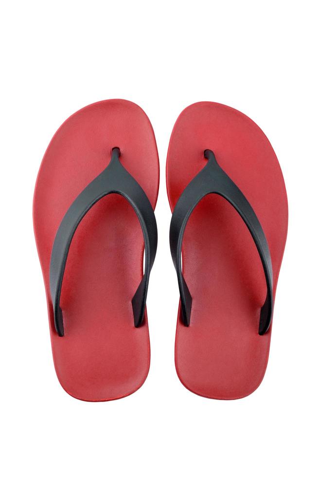 röda gummiflip flops på en vit bakgrund foto