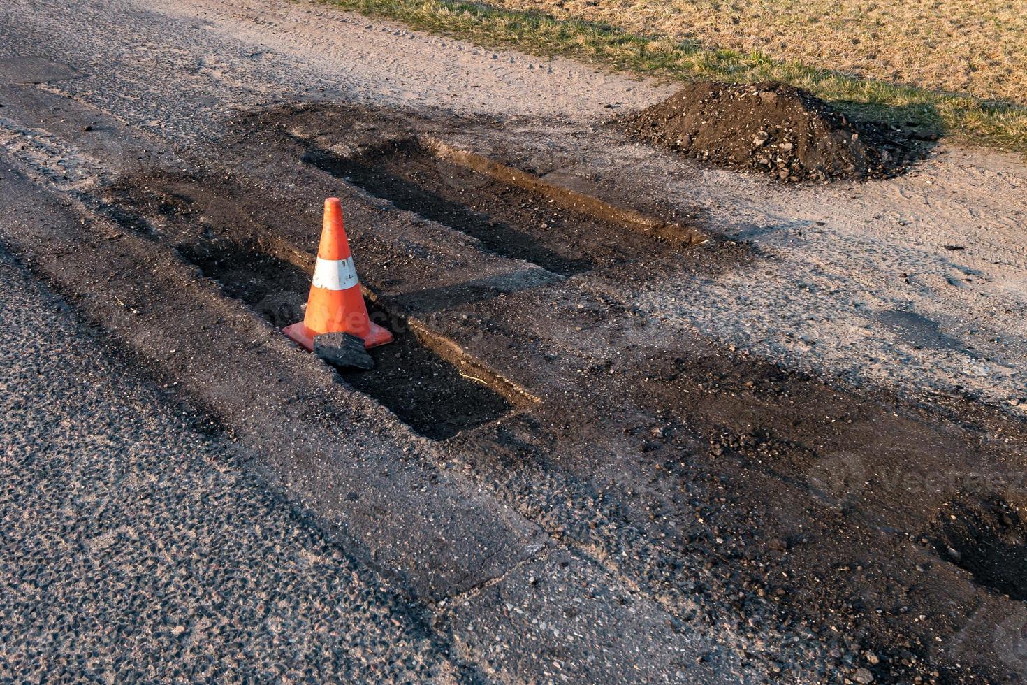 vit orange trafikfara kon på asfaltväg reparation foto