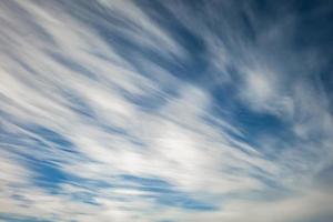 blå himmel bakgrund med små stratus cirrus randiga moln. klarningsdag och bra blåsigt väder foto