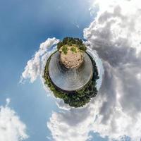 liten planetomvandling av sfäriskt panorama 360 grader. sfärisk abstrakt flygfoto i fält nära floden med fantastiska vackra moln. utrymmets krökning. foto