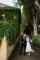 ungt par bruden och brudgummen i en vit kort klänning foto