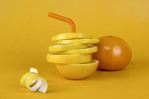 citron frukt skiva i lager med skal och saftig apelsin isolerad på gul bakgrund. saftig citron skivad för fruktreklamdesign foto