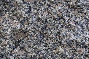 vacker bakgrund av grå-röd granit. granit sten närbild. foto