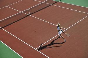 ung kvinna spela tennis foto