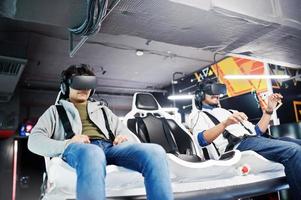 två unga indianer har roligt med en ny teknik för ett vr-headset i virtuell verklighetssimulator. foto