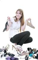 ganska ung kvinna med att köpa skor beroende, isolerad på vit bakgrund foto