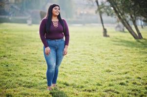 söt latino xxl modell tjej från ecuador bär på violett blus poserade på gatan. foto