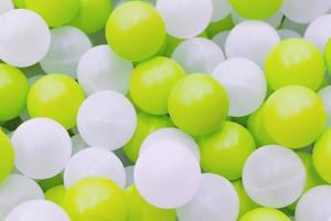 närbild av plast vita och gula bollar i torr pool på lekplatsen foto