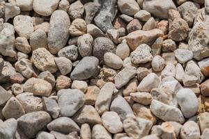 grus bakgrundsstruktur. närbild av små stenar på marken foto