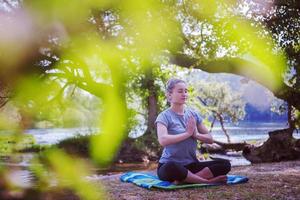 kvinna som mediterar och gör yogaövningar foto