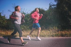 ungt par joggar längs en landsväg foto