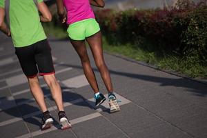 ung leende multietnisk par joggning i de stad foto