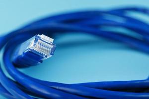 blå Ethernet kabel- sladd lappa sladd på en blå bakgrund med fri Plats foto