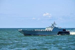 stor modern grå örlogsfartyg segling i fortfarande blå hav vatten. internationell säkerhet, ryska Marin foto