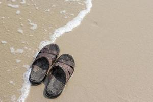 gammal sandaler på de strand foto