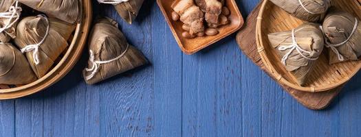 zongzi - drakbåtsfestival koncept ris dumpling, traditionell kinesisk mat på blå trä bakgrund för duanwu festival, ovanifrån, platt lekmannadesignkoncept. foto