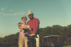 porträtt av par på golf kurs foto