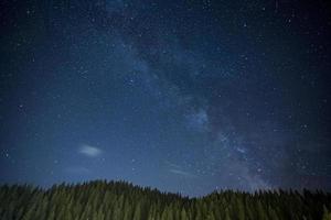 nattlandskap med fält på kullar och Vintergatan himmel i bulgarien. foto