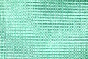 stänga upp textur av turkos grov väva klädsel tyg. dekorativ textil- bakgrund foto