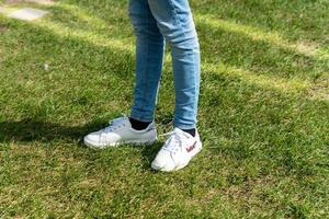 flicka tonåring mode. mager jeand och vit sneakers. tillfällig se. sommar promenad. foto