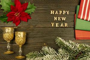 Lycklig ny år 2021 celebration.champagne glasögon och julstjärna på trä- bakgrund. platt lägga. foto