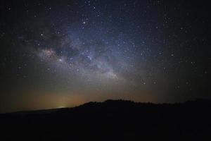 mjölkig sätt galax med stjärnor över moutain på phu hin rong kla nationell park, phitsanulok thailand, lång exponering fotografi.med spannmål foto