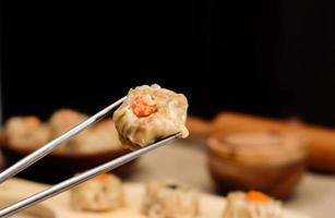 stänga upp kinesisk ångad dimsum eller dämpa belopp, på ätpinnar, traditionell kök foto