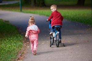 pojke och flicka med cykel foto