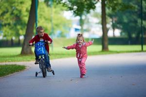 pojke och flicka med cykel foto