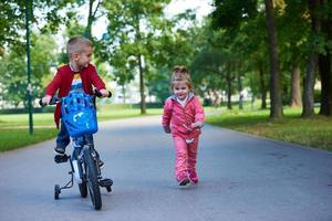 pojke och flicka med cykel foto