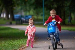 pojke och flicka med cykel foto