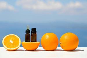 aromaterapi eteriska oljor i flaskor med apelsiner foto