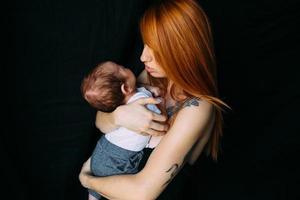 ung mor kvinna innehav henne barn bebis foto