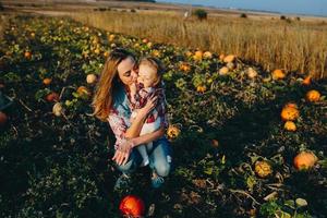 mor och dotter på en fält med pumpor foto