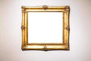 gammal bred barock guld bild ram på brun vägg foto