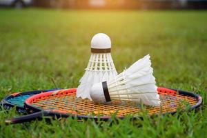 badminton utomhus utrustning badmintonbollar och badminton racketar, på gräsmatta, mjuk och selektiv fokus på fjäderbollar, utomhus- badminton spelar begrepp foto