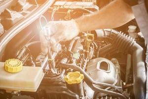 mekaniker arbetar och reparerar bil i bilservicecenter foto